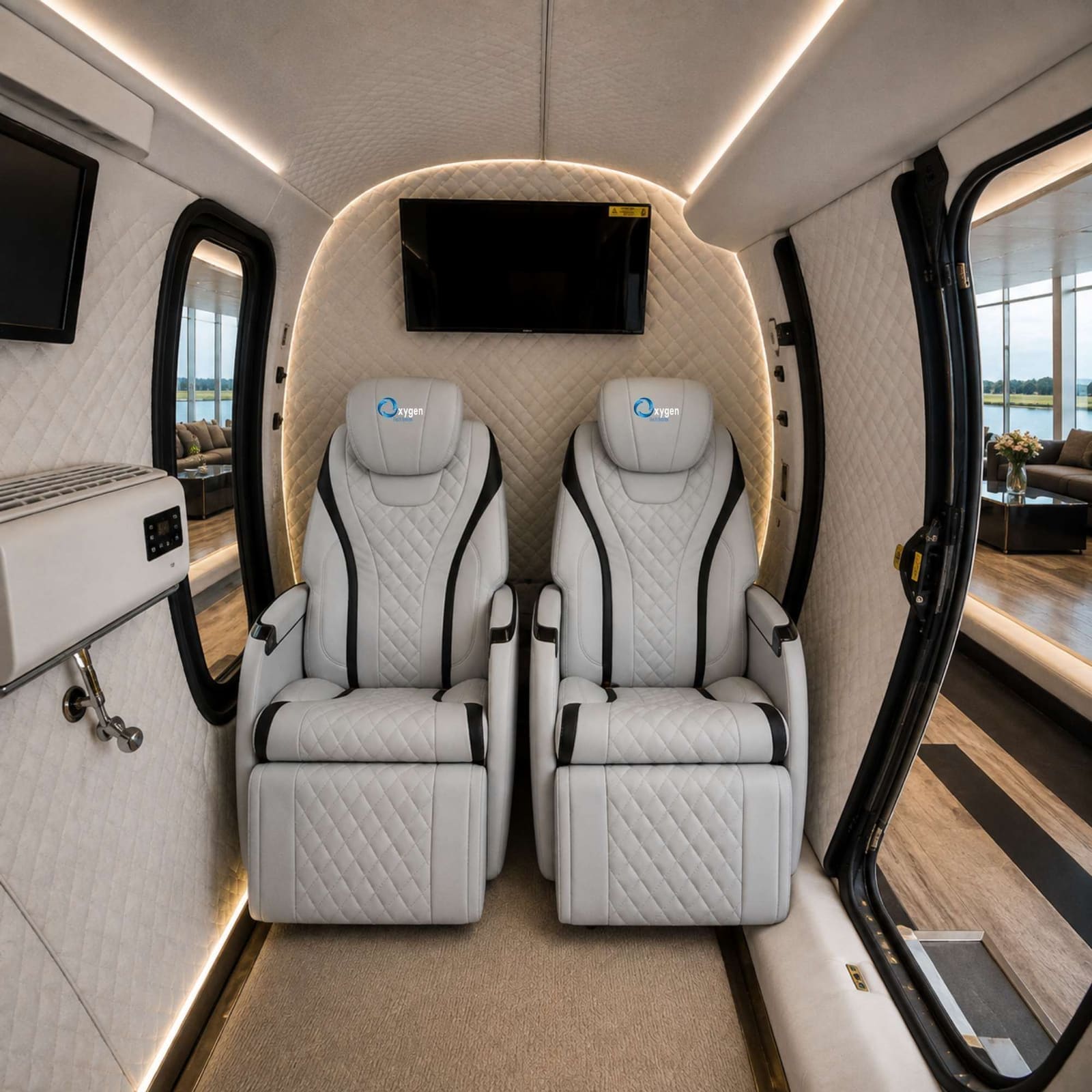 Interior of the ExS64 chamber showing two custom white quilted leather recliner seats with the Oxygen Health Systems logo, a wall-mounted TV, arched viewing windows, and the control panel