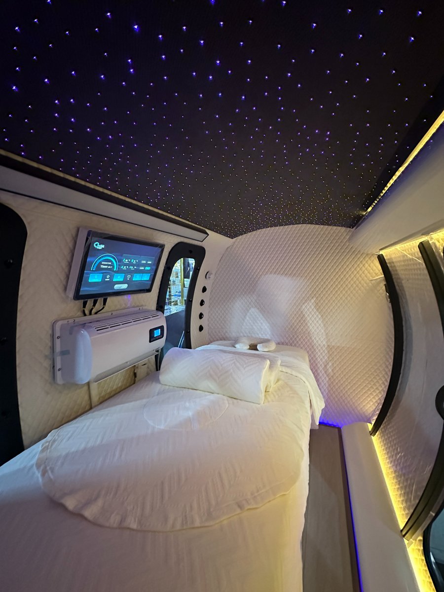 ExS64 bed configuration highlighting the dense fiber-optic starlight ceiling glowing above a white bed, touchscreen control, and air-conditioning unit