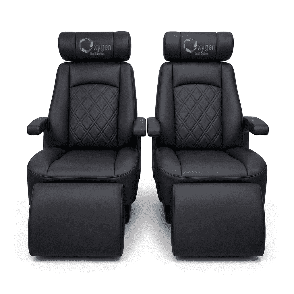 Pair of black quilted leather recliners with extended footrests, diamond-stitched seat backs, padded armrests, and the Oxygen Health Systems logo embroidered on the headrests