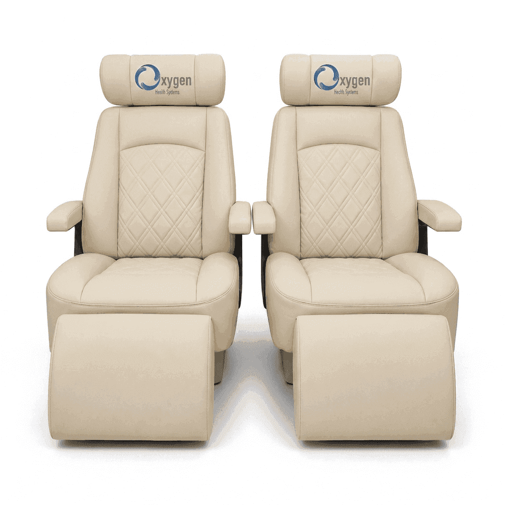 Pair of cream quilted leather recliners with extended footrests, diamond-stitched seat backs, padded armrests, and the Oxygen Health Systems logo embroidered on the headrests