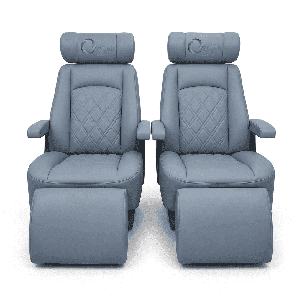 Pair of powder gray quilted leather recliners with extended footrests, diamond-stitched seat backs, padded armrests, and the Oxygen Health Systems logo embroidered on the headrests