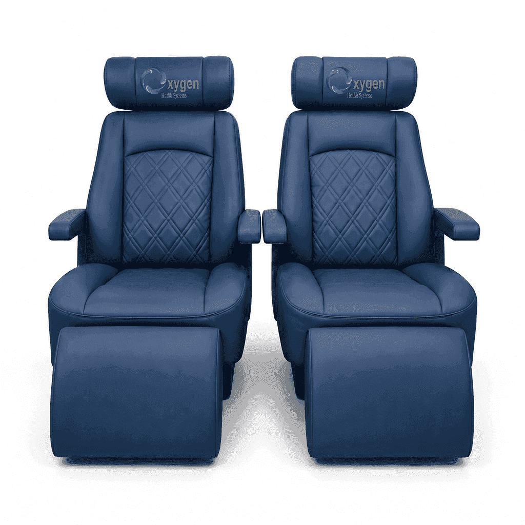 Pair of navy blue quilted leather recliners with extended footrests, diamond-stitched seat backs, padded armrests, and the Oxygen Health Systems logo embroidered on the headrests